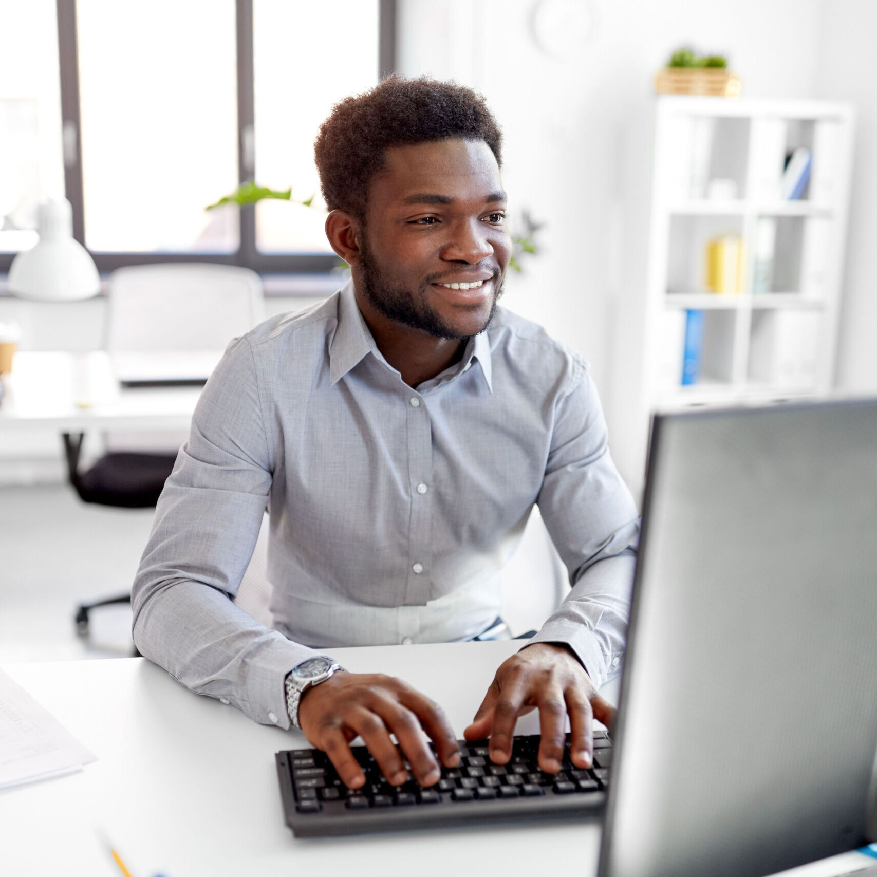 content-management-system-guy-at-desktop-computer-smiling