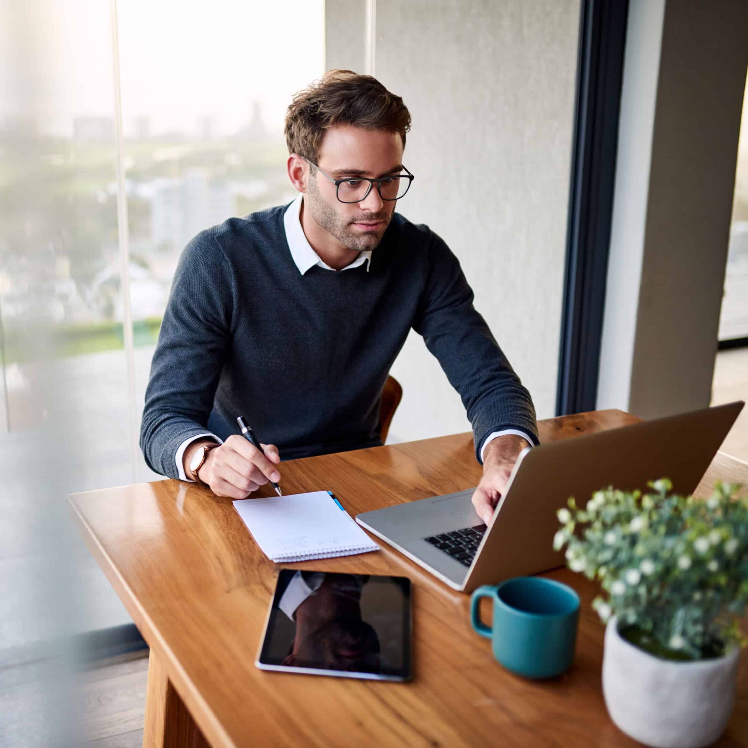 Accounts Payable Automation young man working on a laptop remotely for accounts payable automation gets work to your remote team